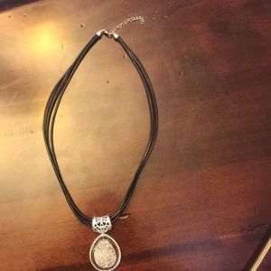 Pendant necklace with triple strand leather cord